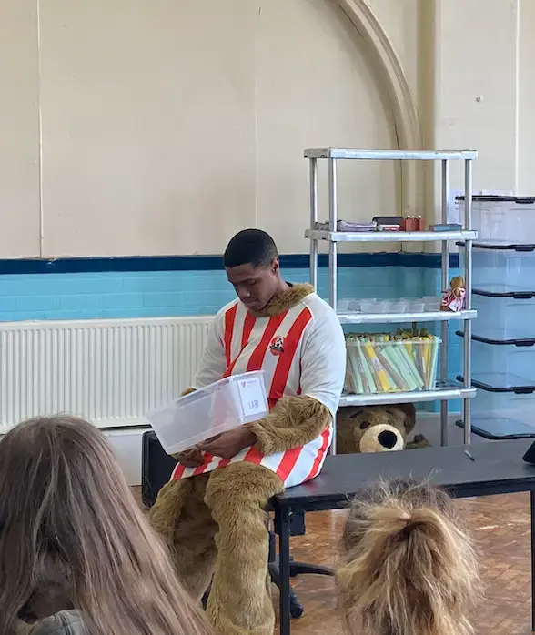 aaron corbett dressed as a bear sitting on a table